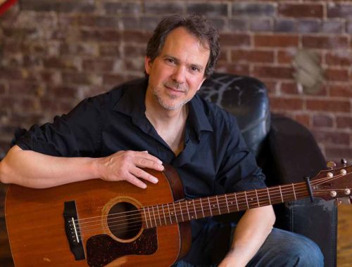 Portrait of Dave Isaacs with Guild guitar