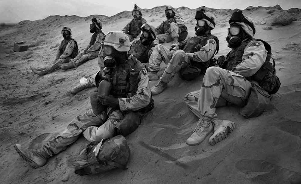 Soldiers, 1-327 Infantry Division, sitting in the Kuwaiti desert