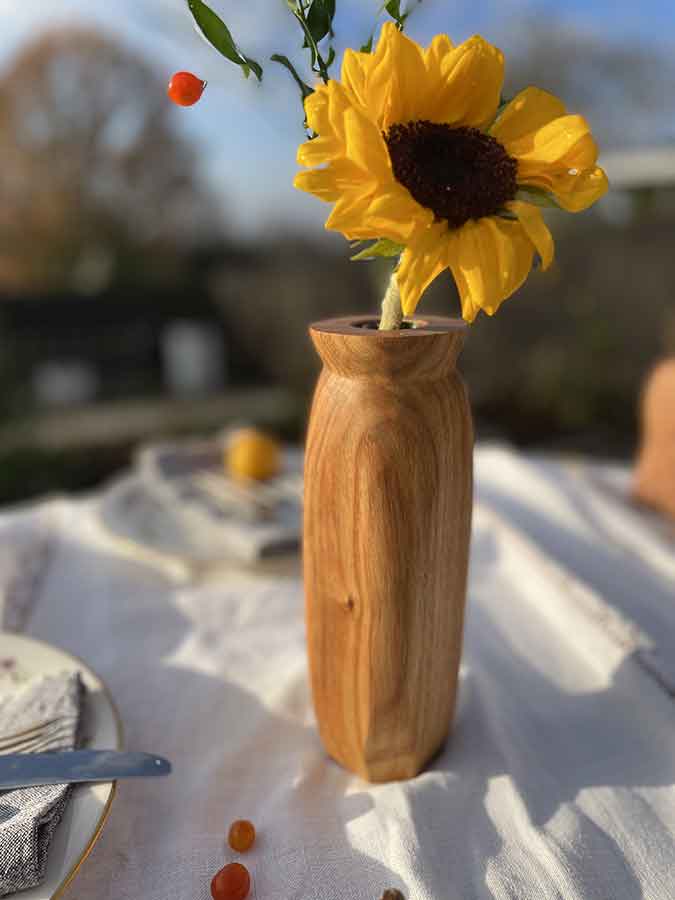 hand-crafted wooden flower vase with yellow flower