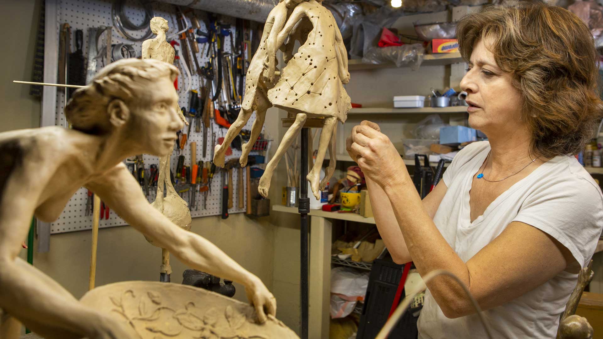 Figurative Sculptor Theresa Dyer working with clay