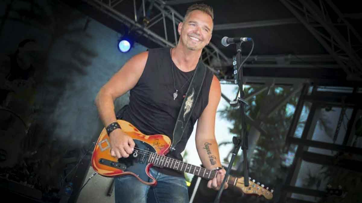 Australian country singer Troy Kemp playing an electric guitar on stage