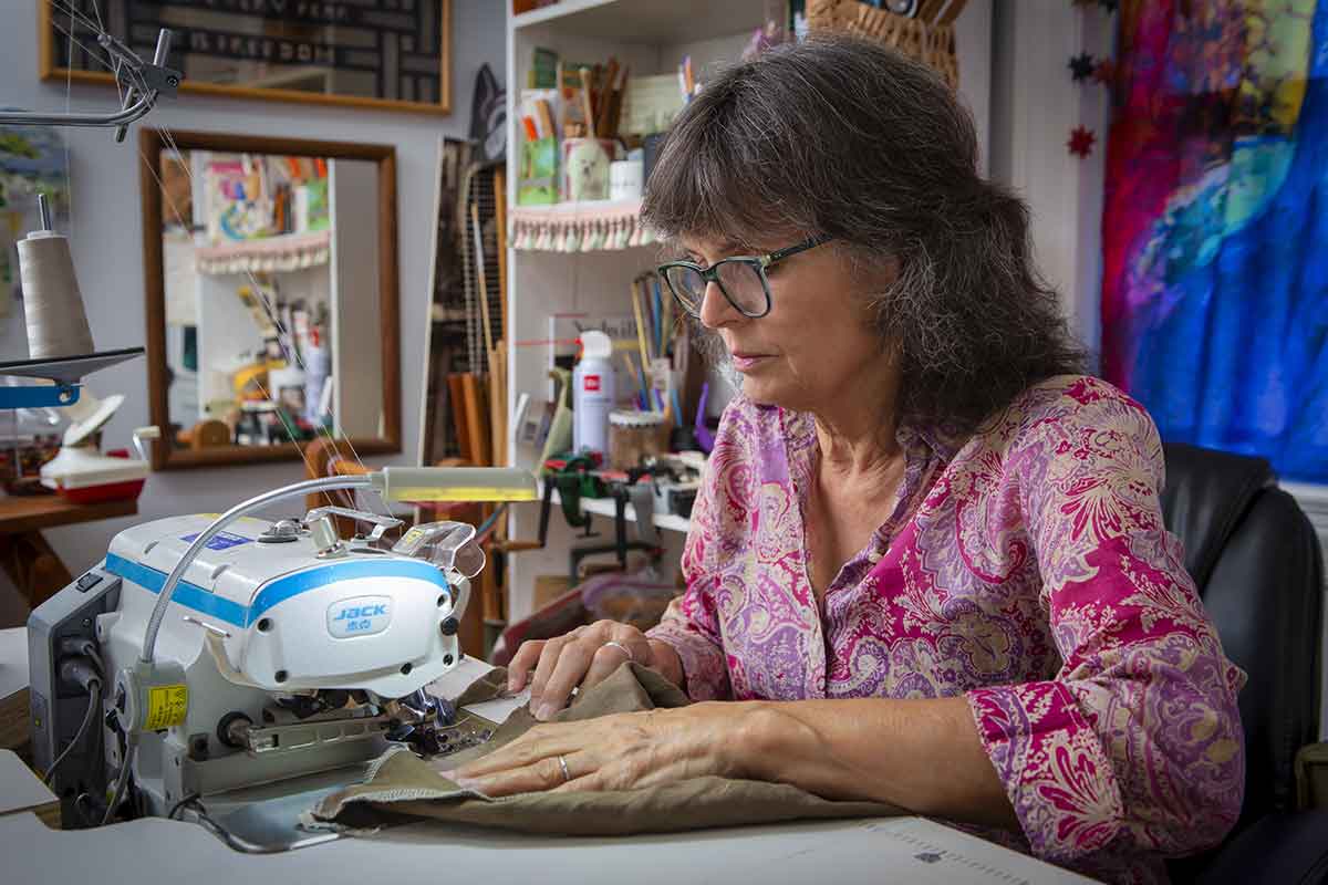 Fiber artist Twyla Lambert sewing