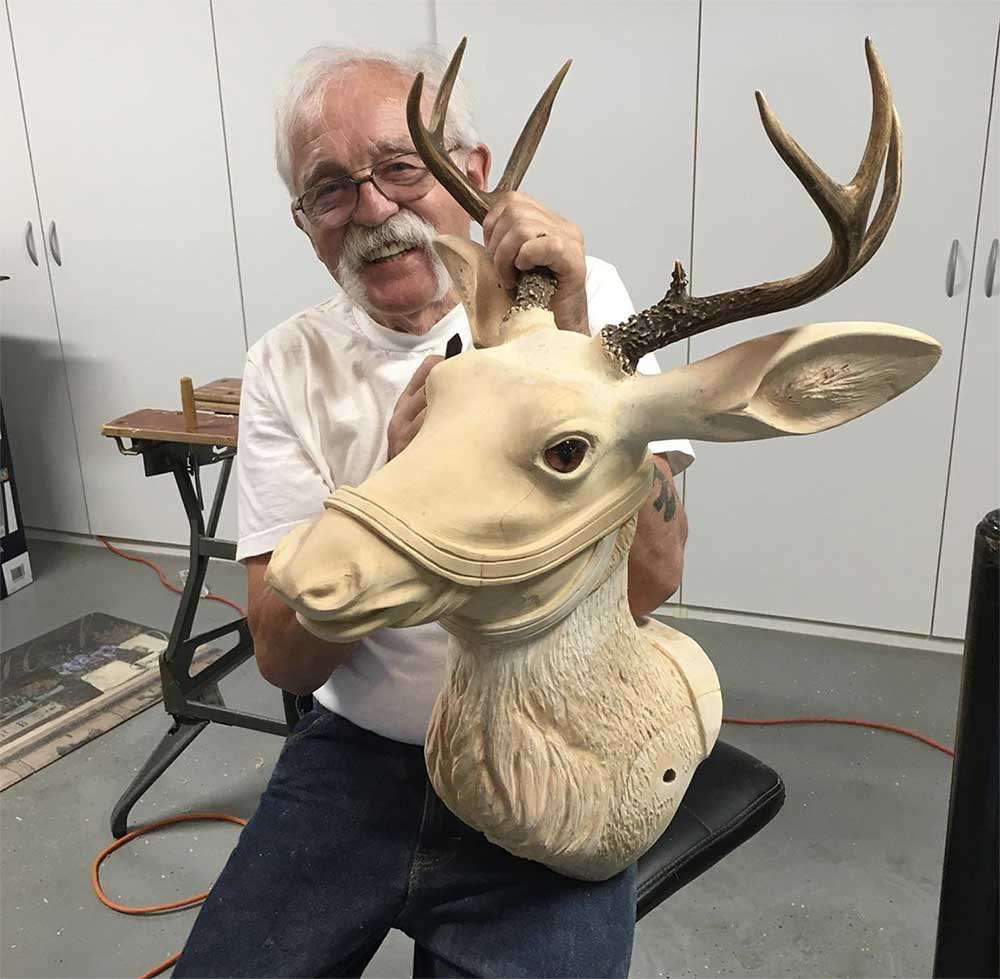 carved wooden carousel deer head and artist