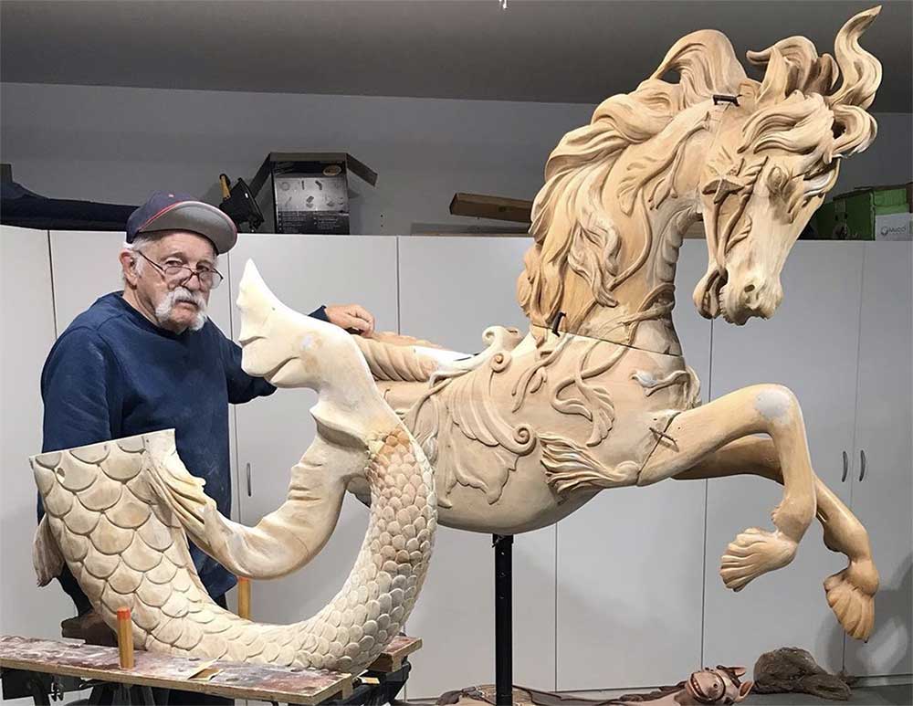 artist with Hippocampus carousel animal