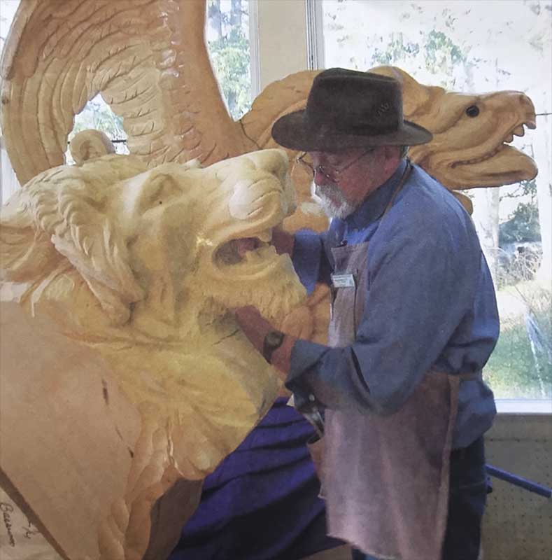artist carving carousel lion