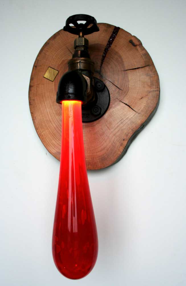 Sculpture of handblown glass water dripping from faucet light fixture