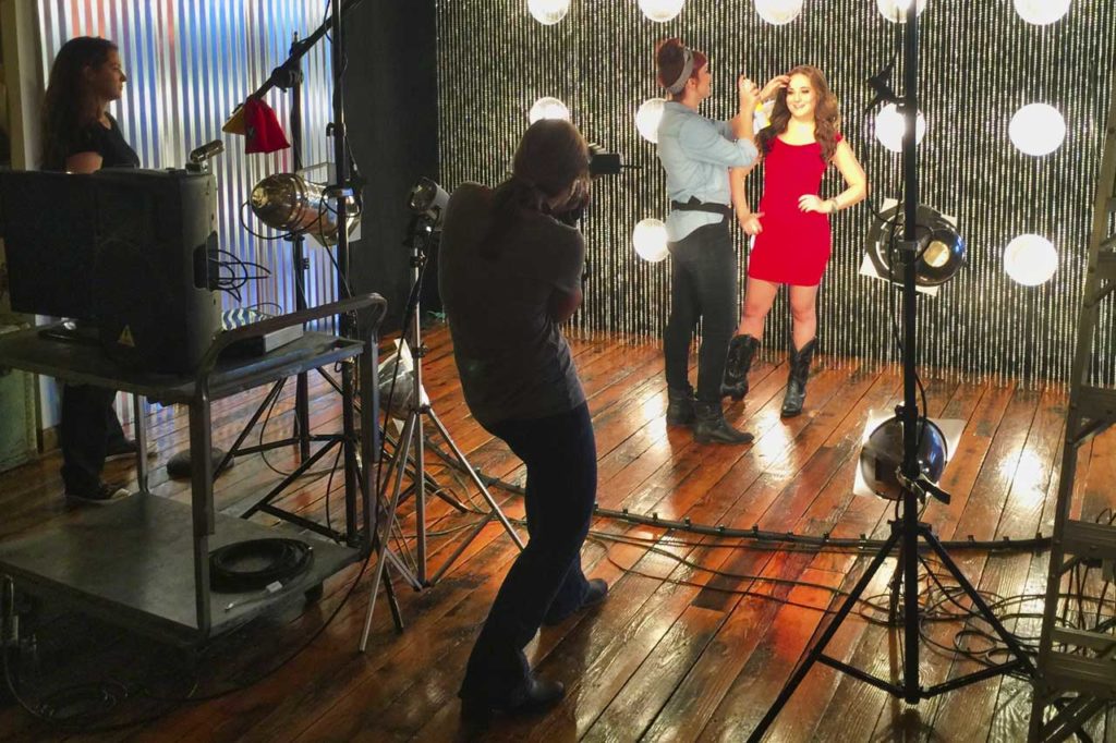 Commercial Photographer shooting woman in red dressin studio