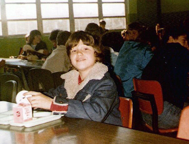 Young boy eating lunch in school lunchroom