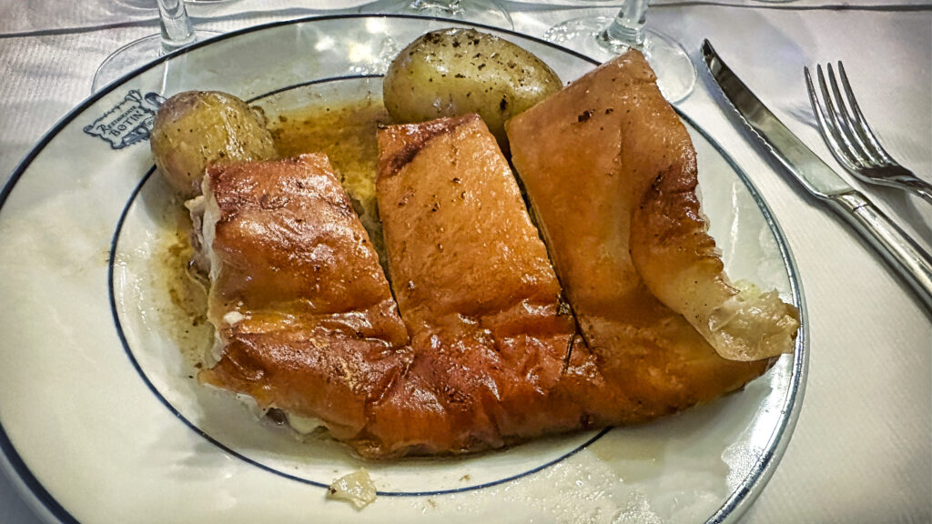 plate of roast suckling pig with potatoes