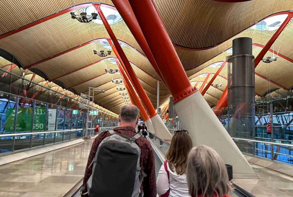 three people walking in Madrid airport
